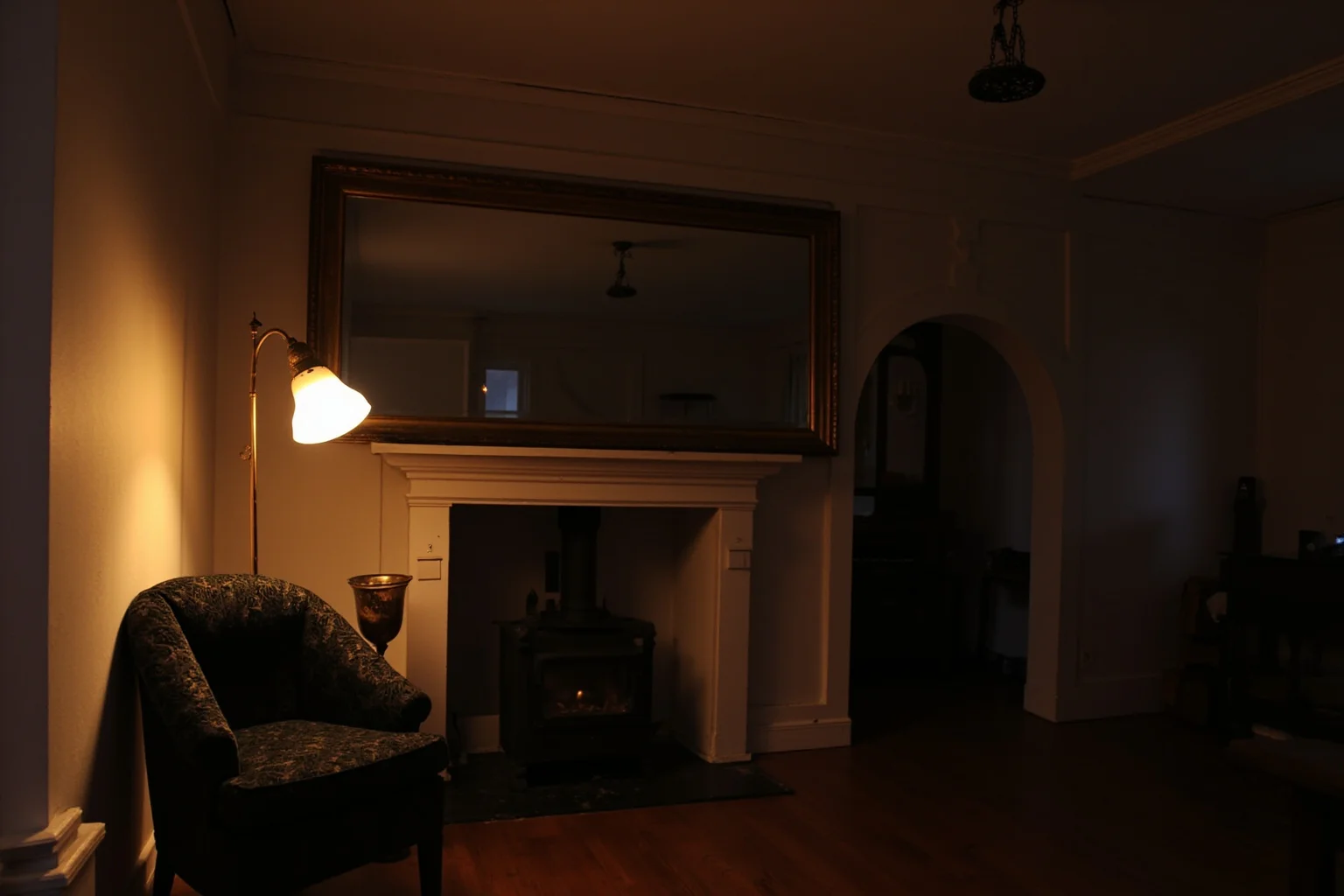 22 Things Every American Home Had in the 1920s 2 A cozy 1920s living room lit by an early electric lamp, with a wired ceiling fixture, styled in period decor