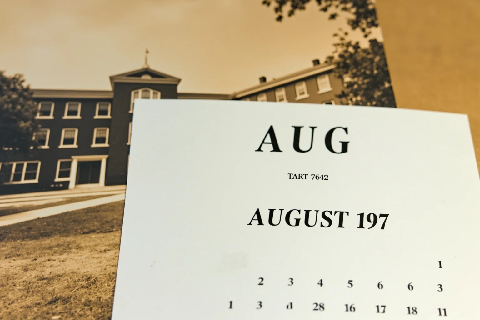 A calendar page turned to August 1971 next to a vintage university campus photo, symbolizing the start date of a historic psychology study