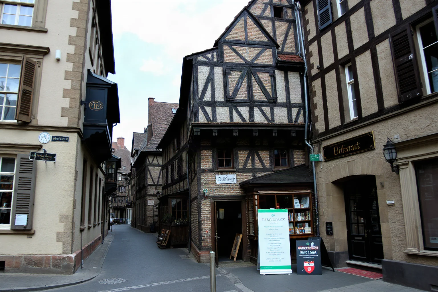 An old European city street scene representing 18th-century Frankfurt, with historic merchant houses and a small red shield sign above a doorway