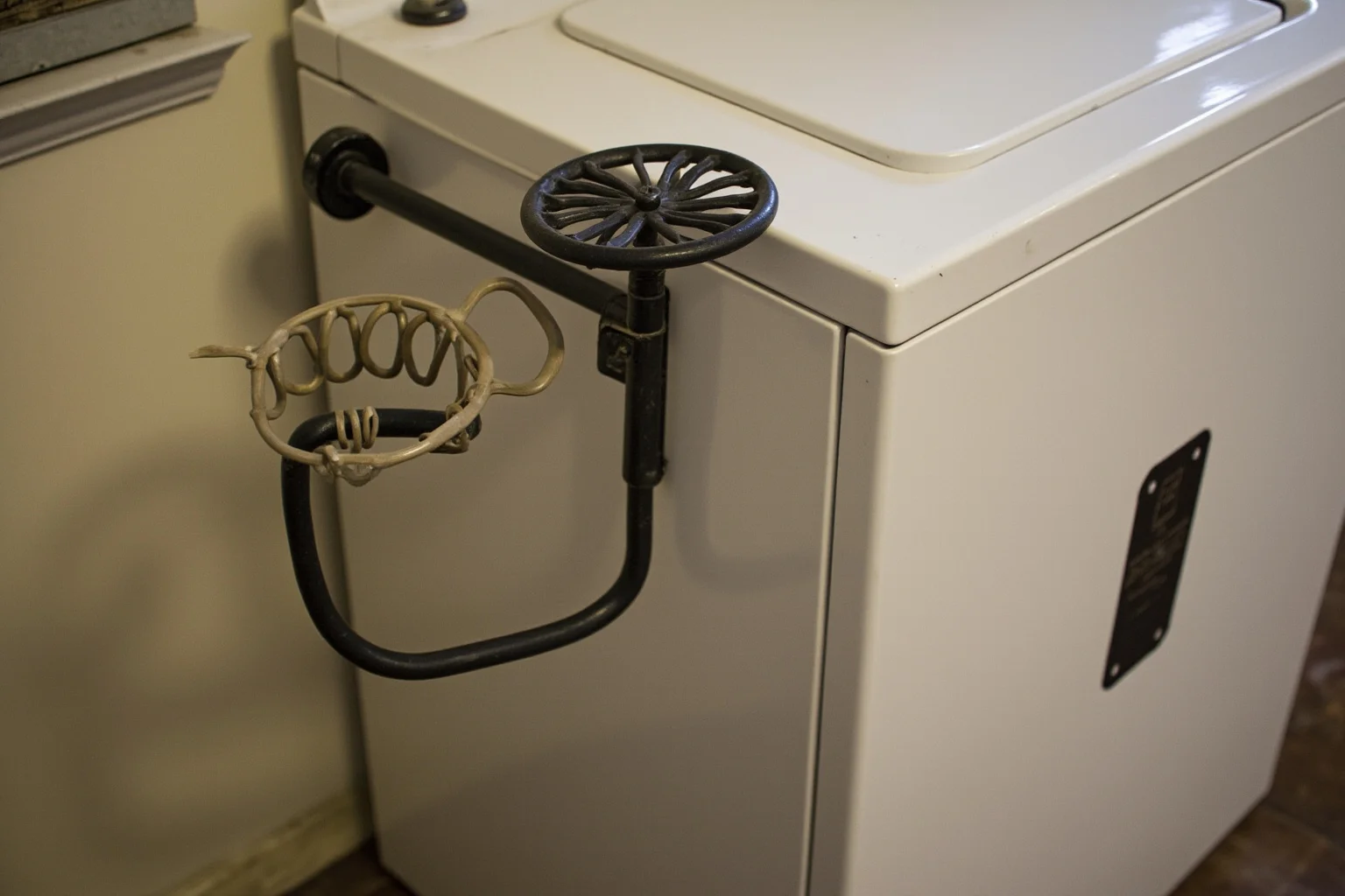 22 Things Every American Home Had in the 1920s 5 A 1920s electric washing machine with a hand-cranked wringer attachment in a home laundry room