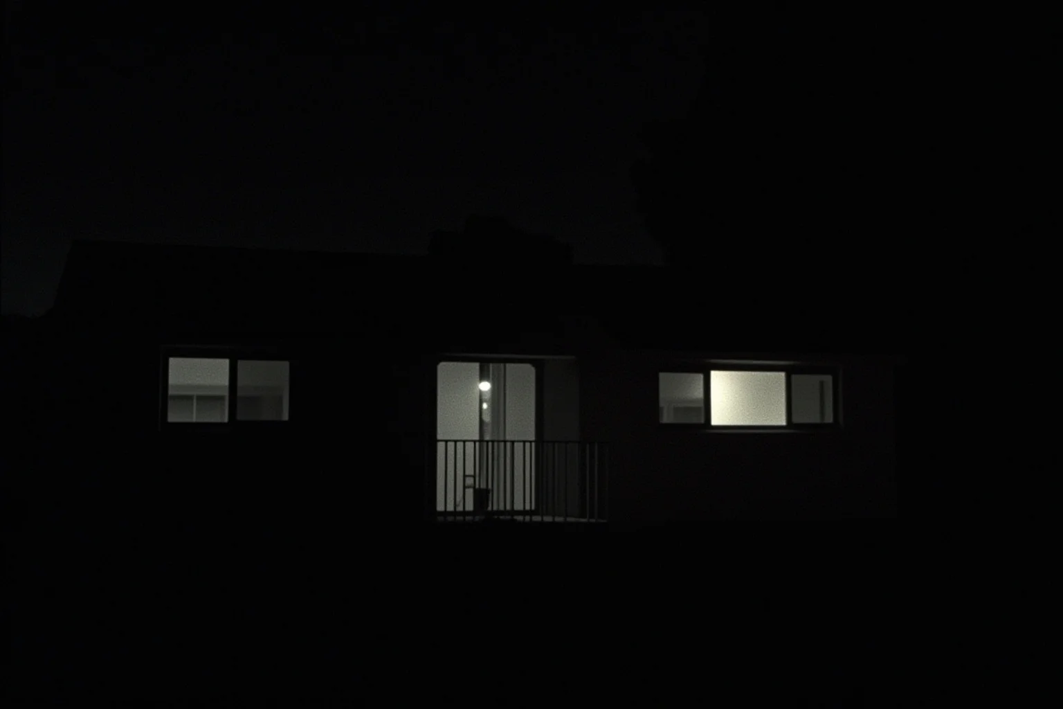 A 1950s American suburban house at night with a single lit window, evoking a hidden atomic-secrets spy ring
