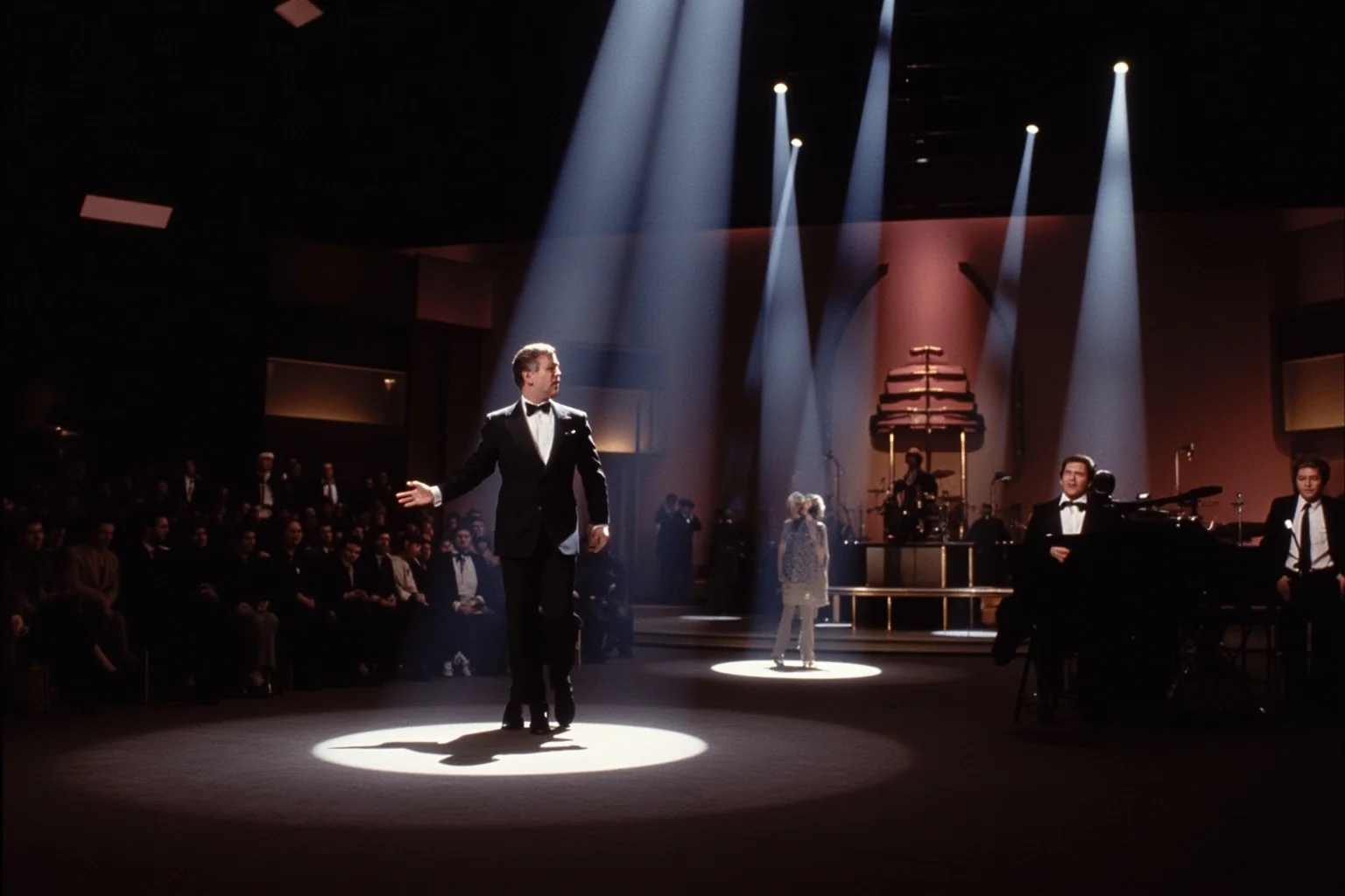 A 1960s television studio stage with dramatic spotlighting for a live comeback performance