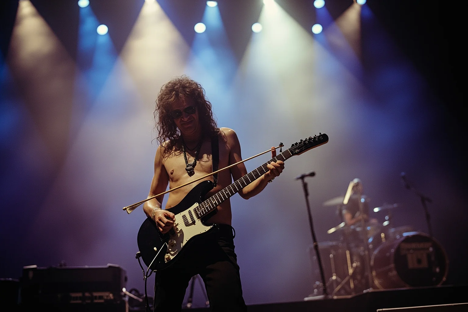 A 1970s rock guitarist on a large arena stage using a violin bow on an electric guitar, dramatic smoke and lighting effects
