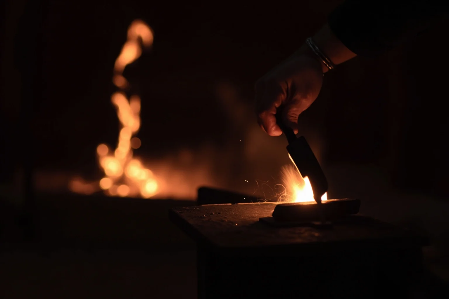 Brutal Forms of Public Humiliation Throughout History 12 A blacksmith's branding iron glowing near a forge in a dim historical workshop scene