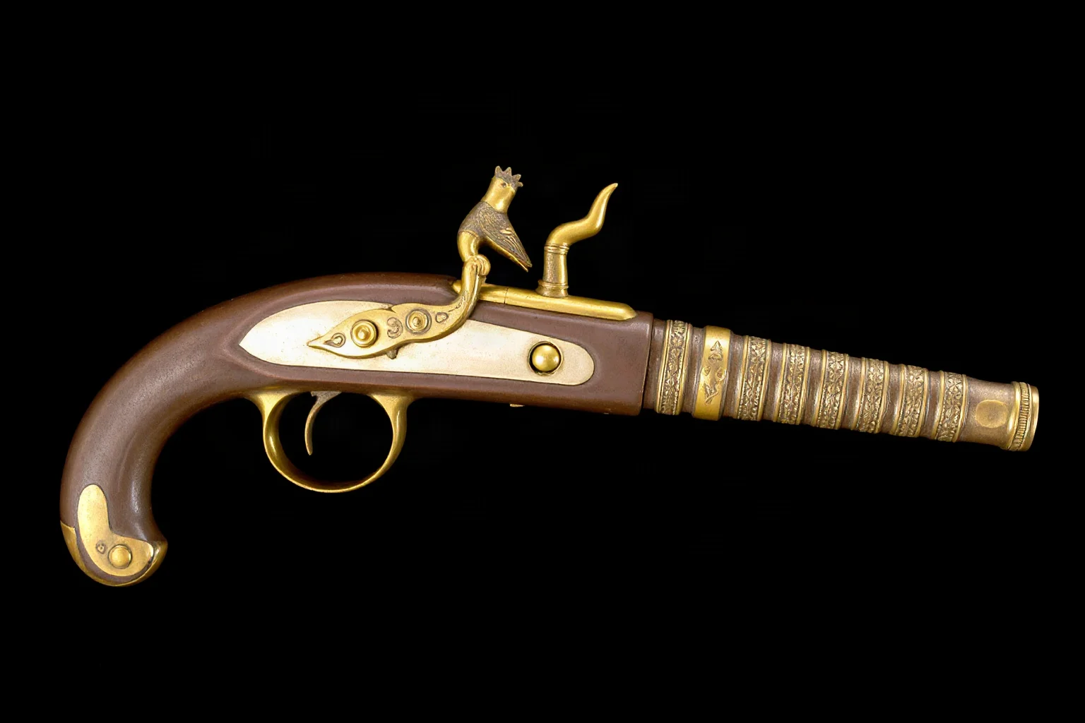 A brass 19th-century duck's foot pistol with four splayed barrels, studio object illustration