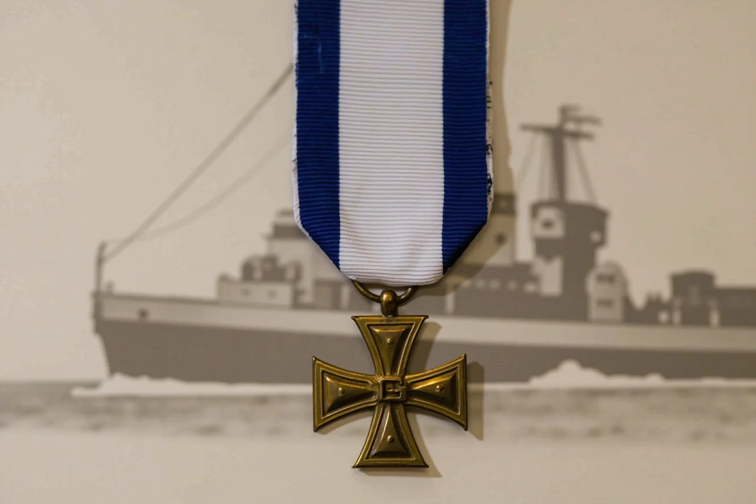 Highest Military Decorations: 20 Rare and Obsolete Medals You'll Never See Again 15 A bronze cross-shaped naval medal on a navy blue and white ribbon, displayed with a small ship silhouette in the background