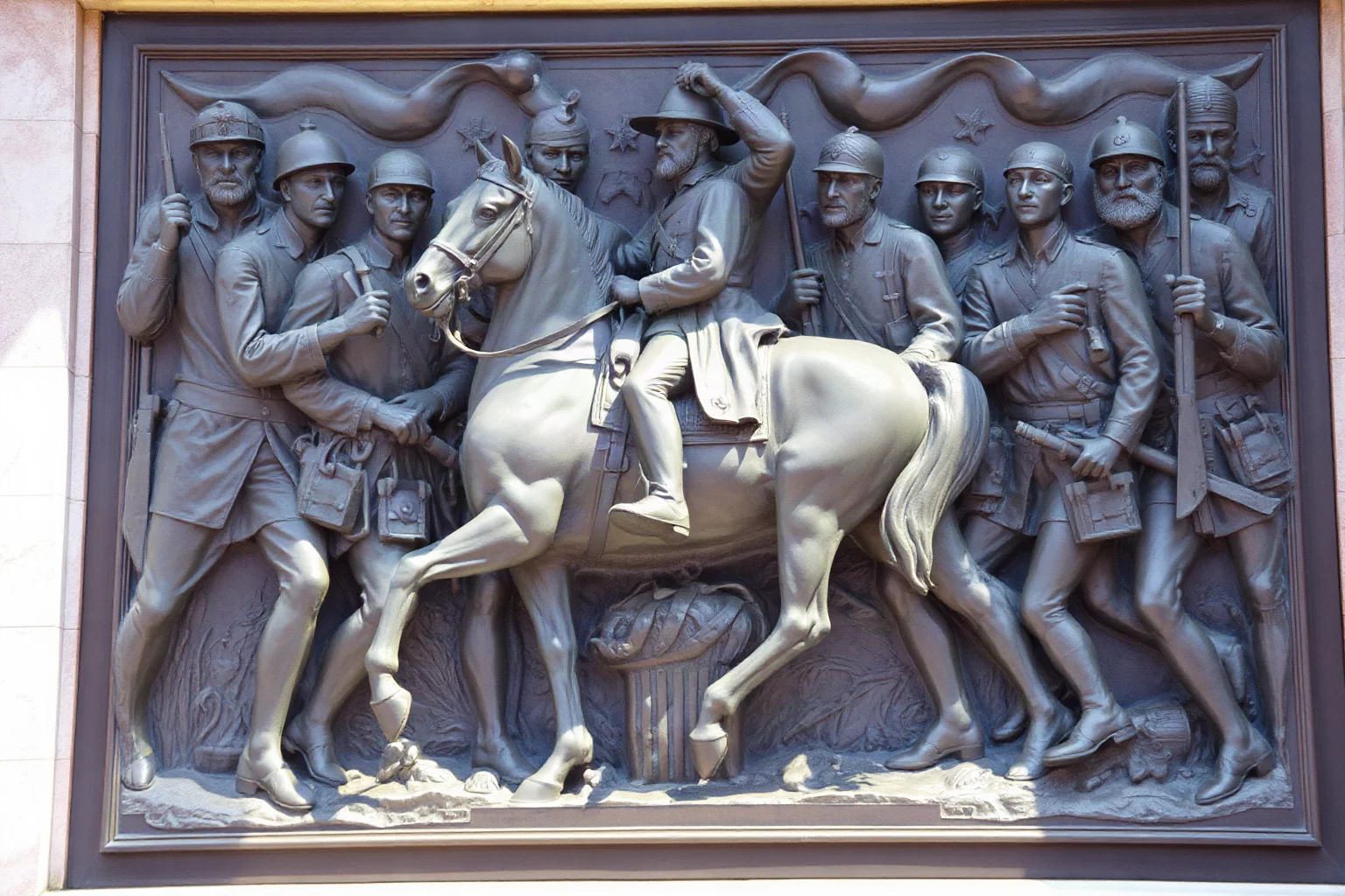 A bronze memorial relief sculpture depicting a mounted Civil War officer leading marching infantry soldiers, in the style of a 19th-century monument