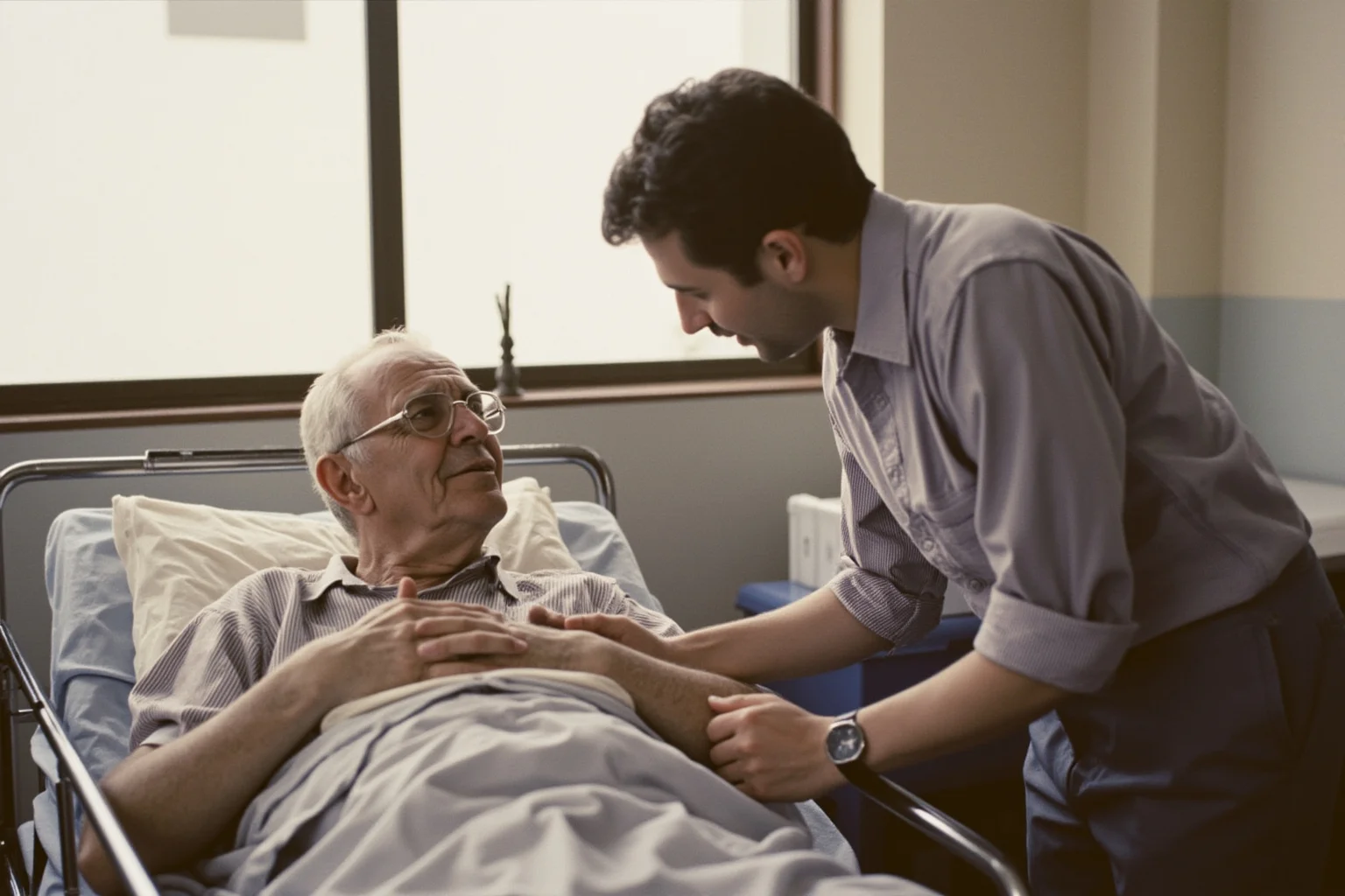 A caring visitor speaking gently with a patient in a clean, dated 1990s hospital ward with soft natural light