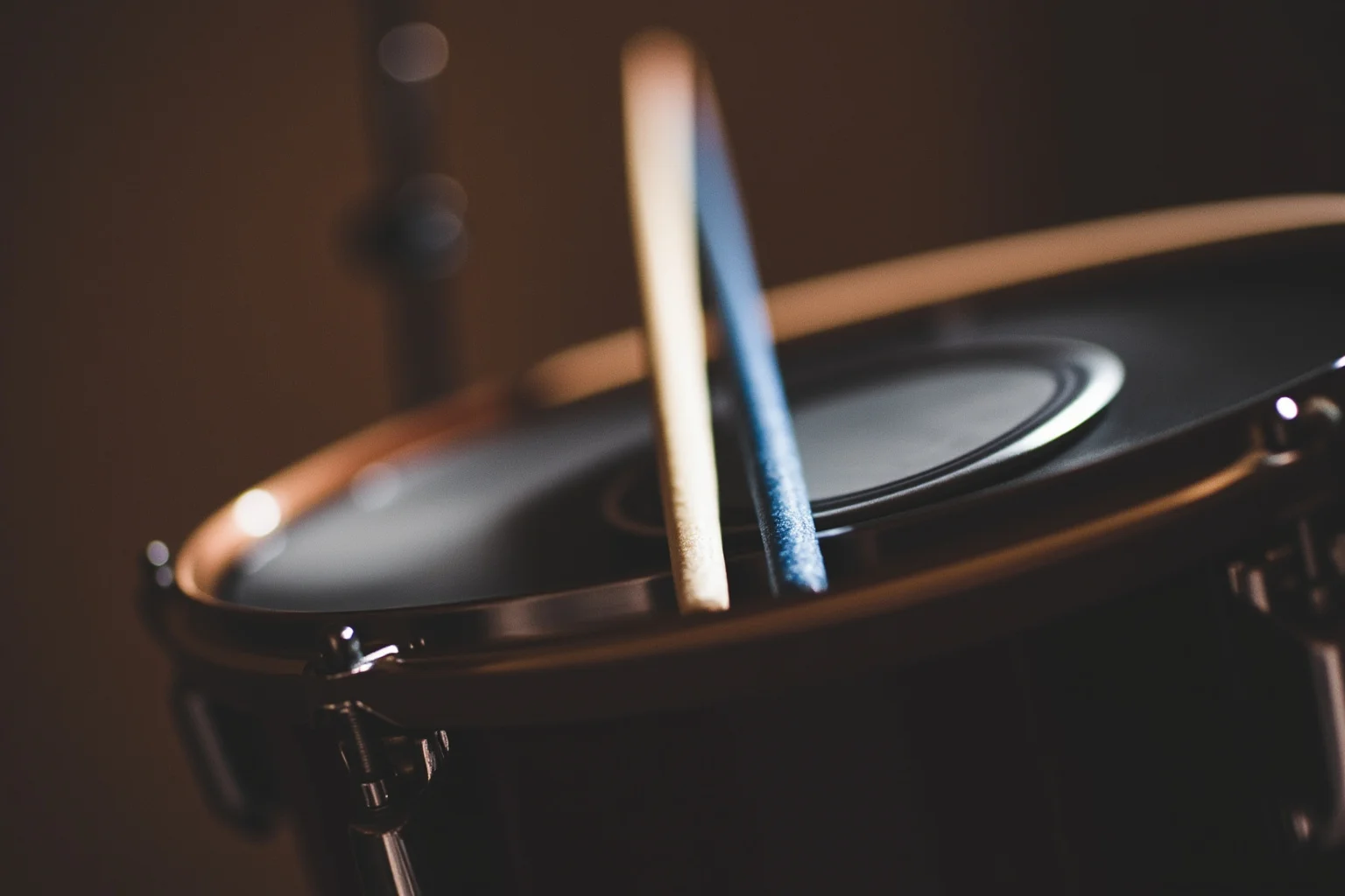 Incredible Facts About the Beatles' Greatest Band History 18 A close-up of drumsticks and a drum kit at an angle suggesting unconventional left-handed setup