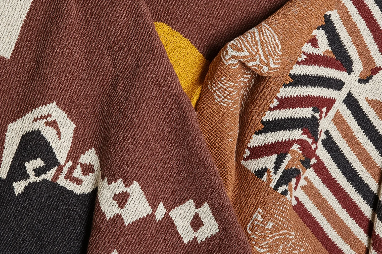 A close-up of intricate woven textile patterns and pottery designs representing diverse Native American art