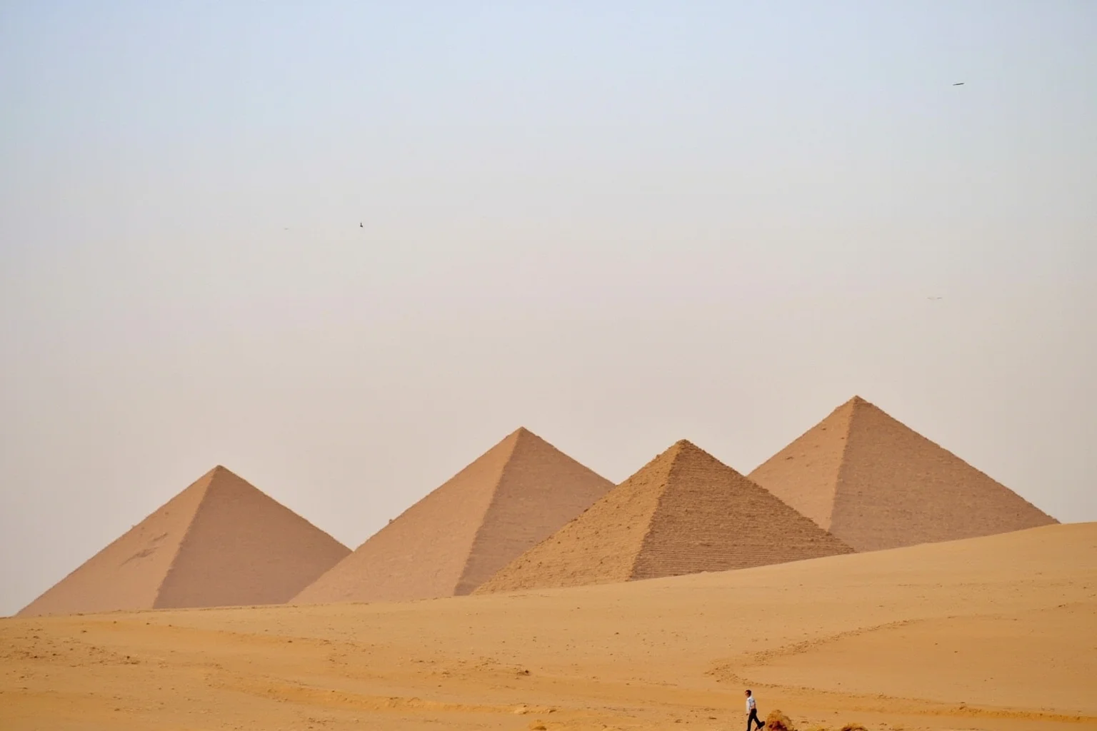 A cluster of steep, narrow pyramids at Meroë rising from the Sudanese desert sand