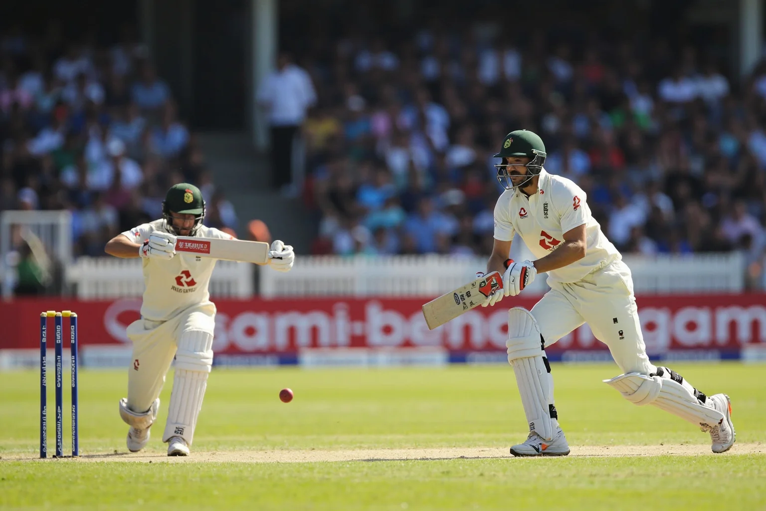 A cricket stadium in India with two batsmen mid-partnership, huge crowd watching a tense final-day chase, warm afternoon light
