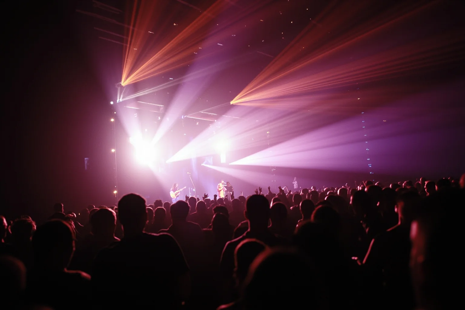 A crowded concert venue in the 1990s with stage lights and an energetic audience