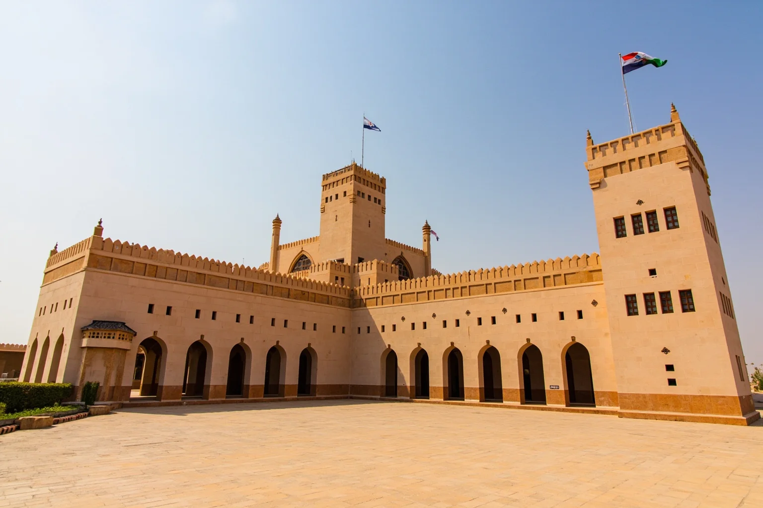 A desert palace with Arabian architectural motifs representing the Sultanate of Oman