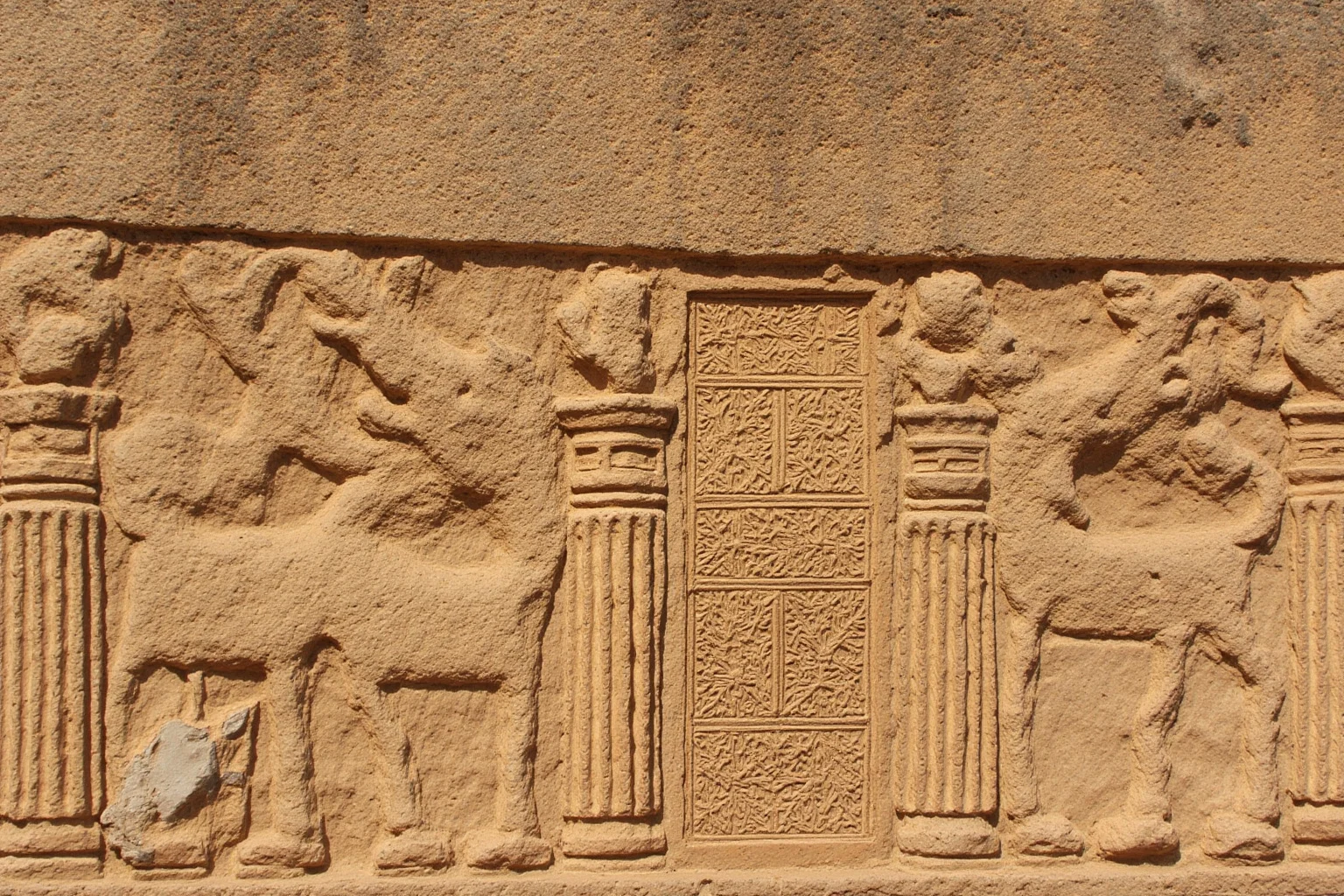 25 Captivating Facts About the Persian Empire 24 A detailed ancient stone relief carving showing bull-headed columns and royal Persian artwork