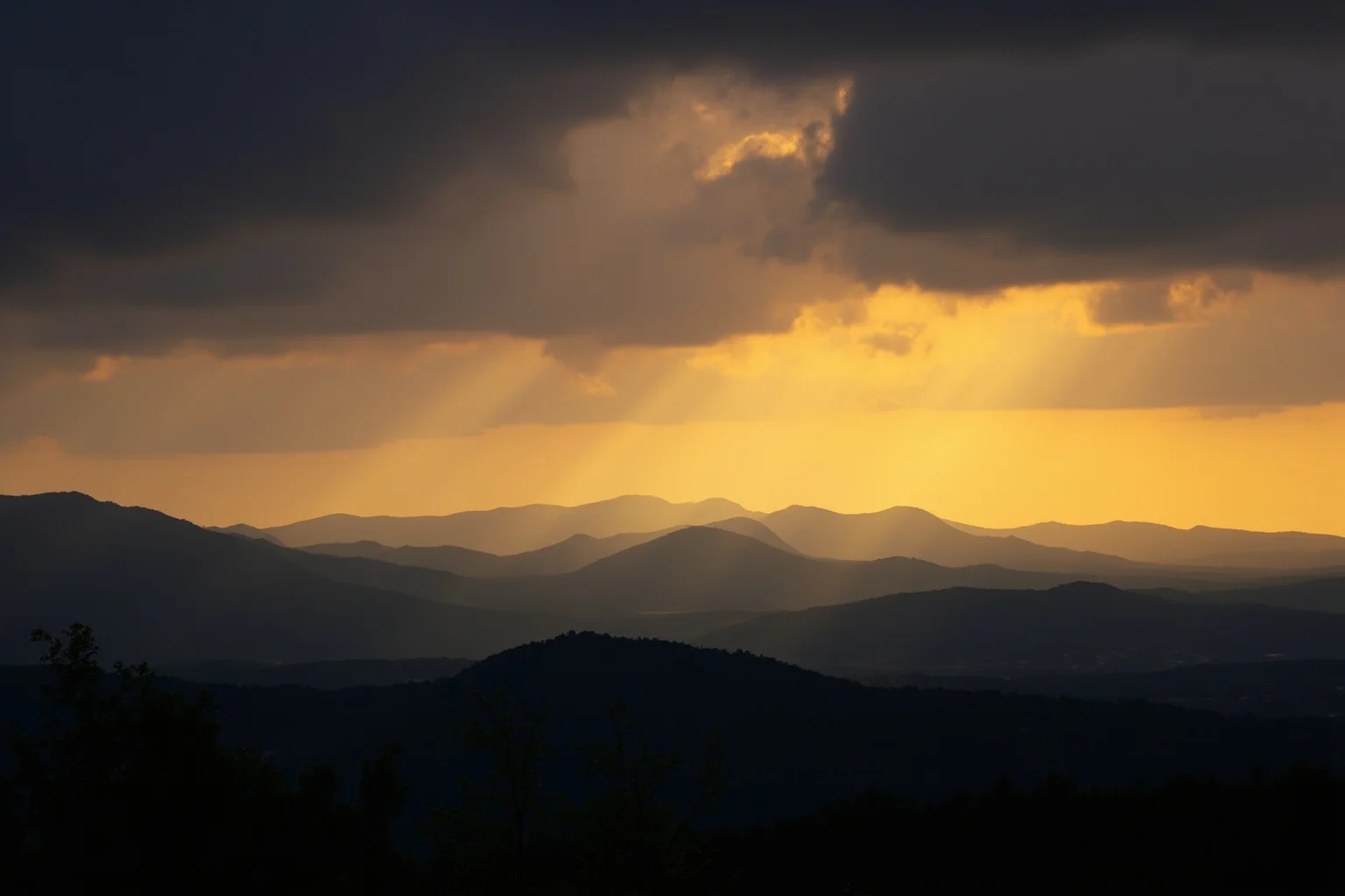 The Human Lightning Rod: The Man Who Was Struck Seven Times 22 A dramatic wide shot of the Blue Ridge Mountains under a glowing stormy sunset sky