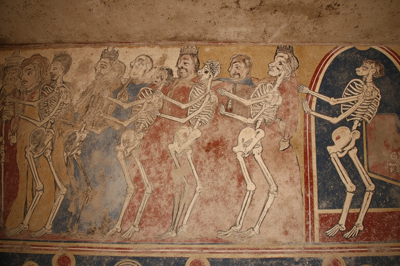 22 Creepiest Pieces of Medieval Art (And the Strange History Behind Them) 4 A faded medieval church mural showing a row of skeletons dancing hand in hand with kings, clergy, and peasants