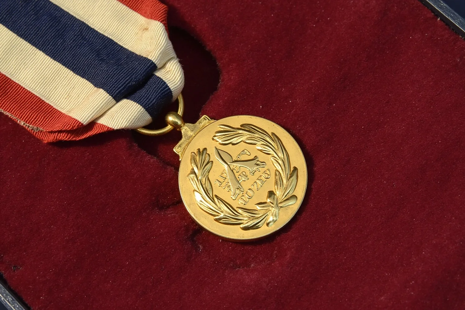 Highest Military Decorations: 20 Rare and Obsolete Medals You'll Never See Again 4 A gold medal featuring a laurel wreath design on a striped ribbon, displayed on velvet, evoking a rare WWII-era Allied commander's honor