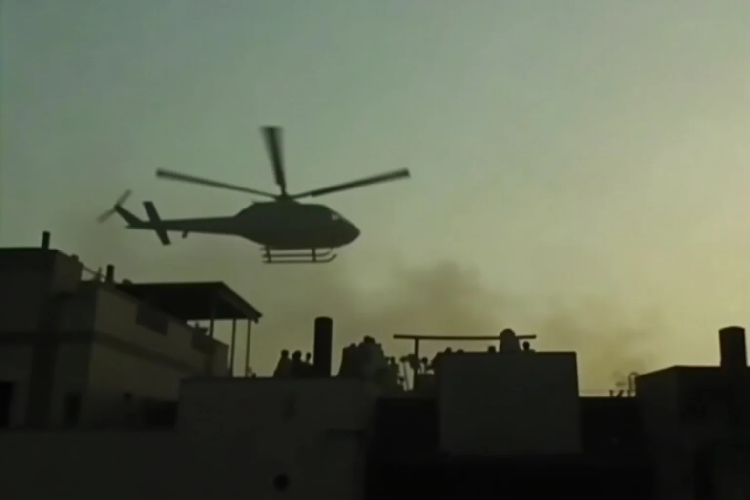 Most Important Historical Events Televised Live 8 A grainy television image of a helicopter lifting off from a rooftop at dusk during a chaotic evacuation scene