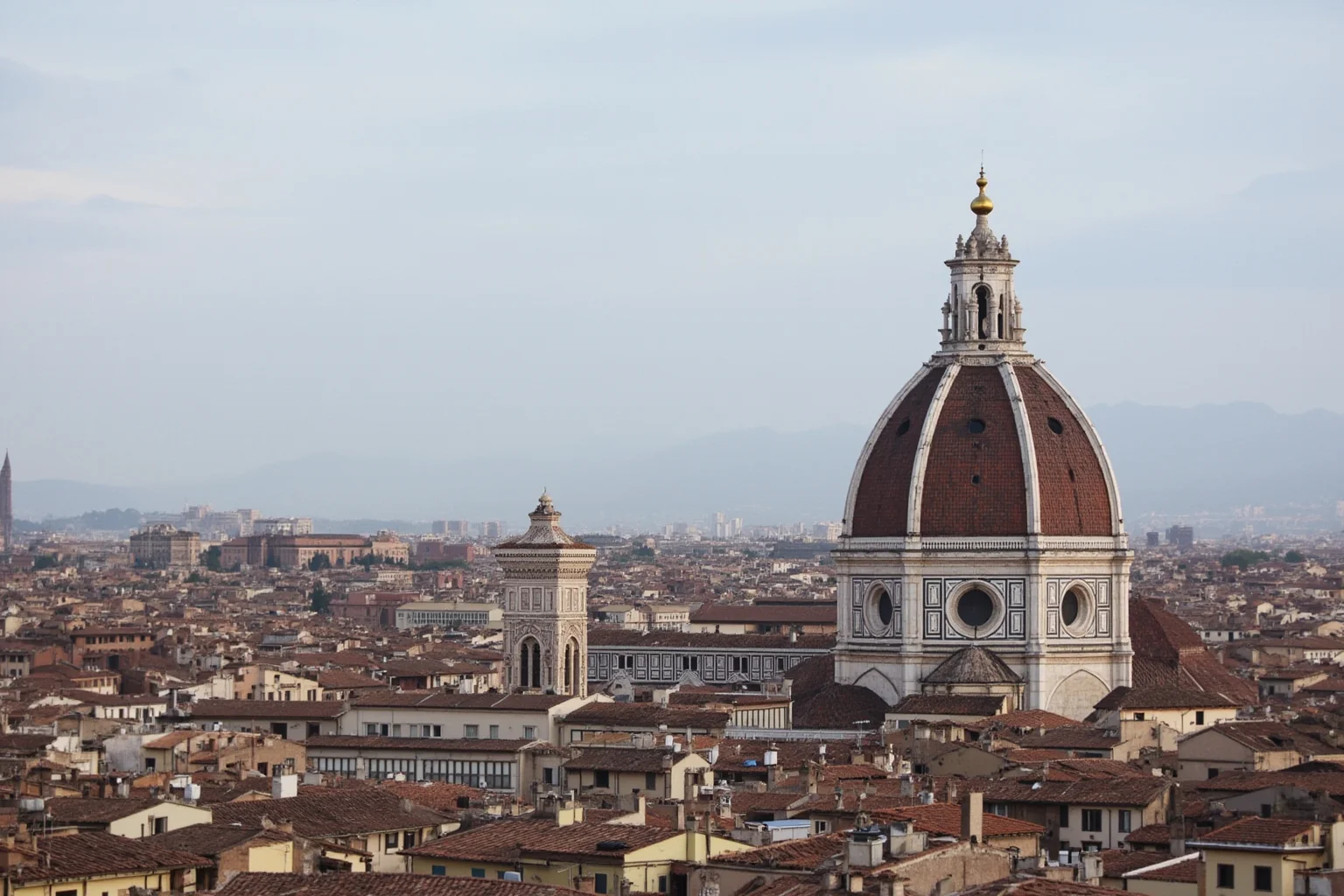 A grand cathedral dome with a coffered double-shell structure rising above a historic Italian city skyline