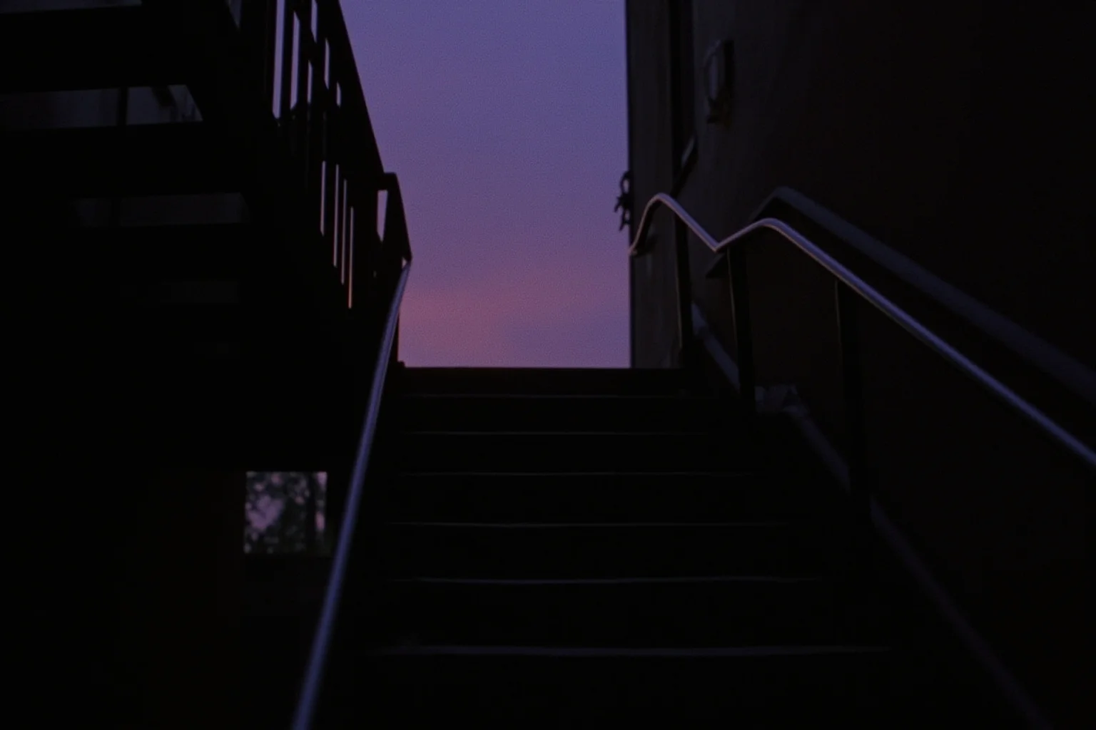 A gritty 1980s New York housing project stairwell at dusk, evoking an ambitious teenager's neighborhood