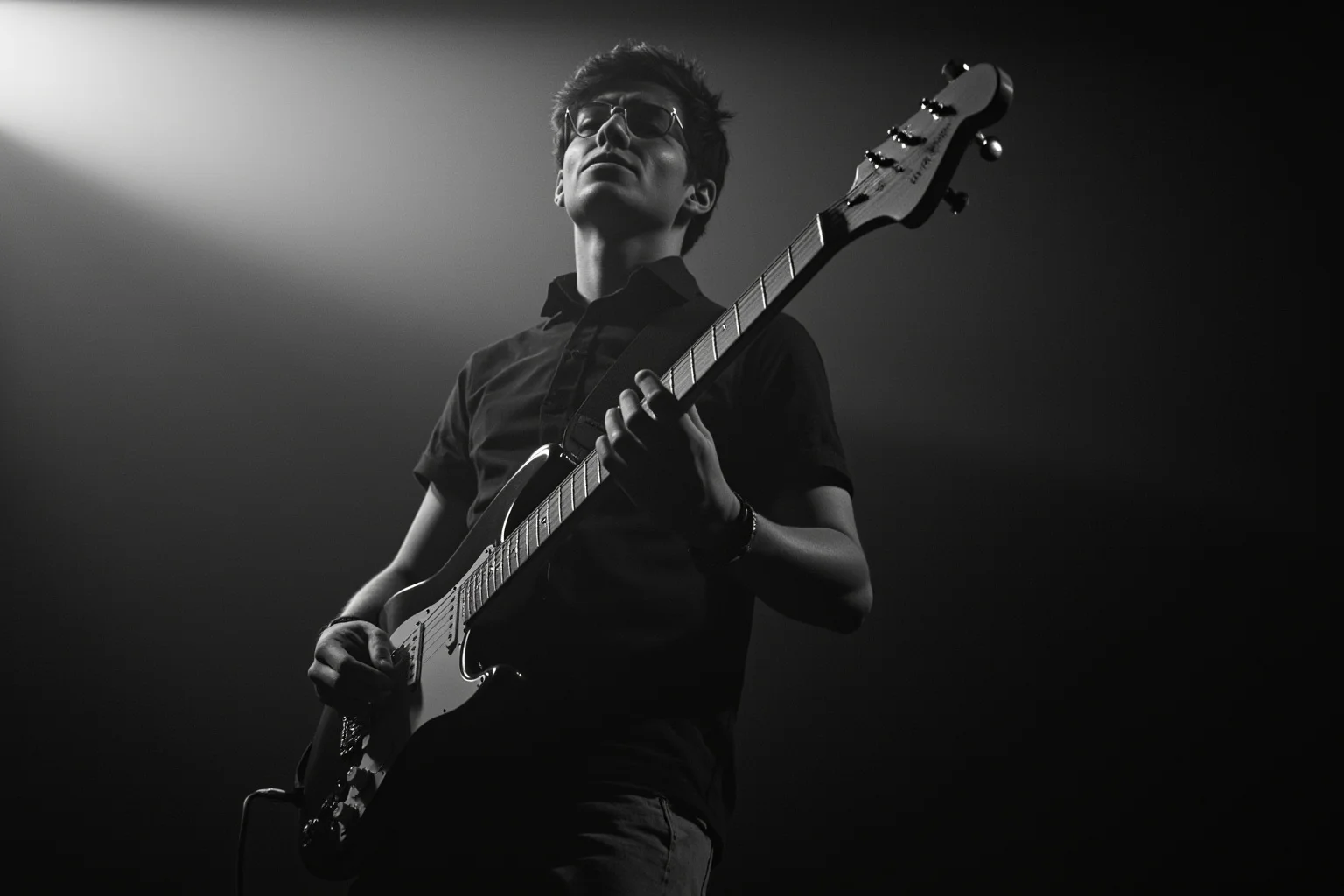 A guitarist playing a slow, emotional solo on a Stratocaster-style guitar, spotlight beam, minimalist stage design