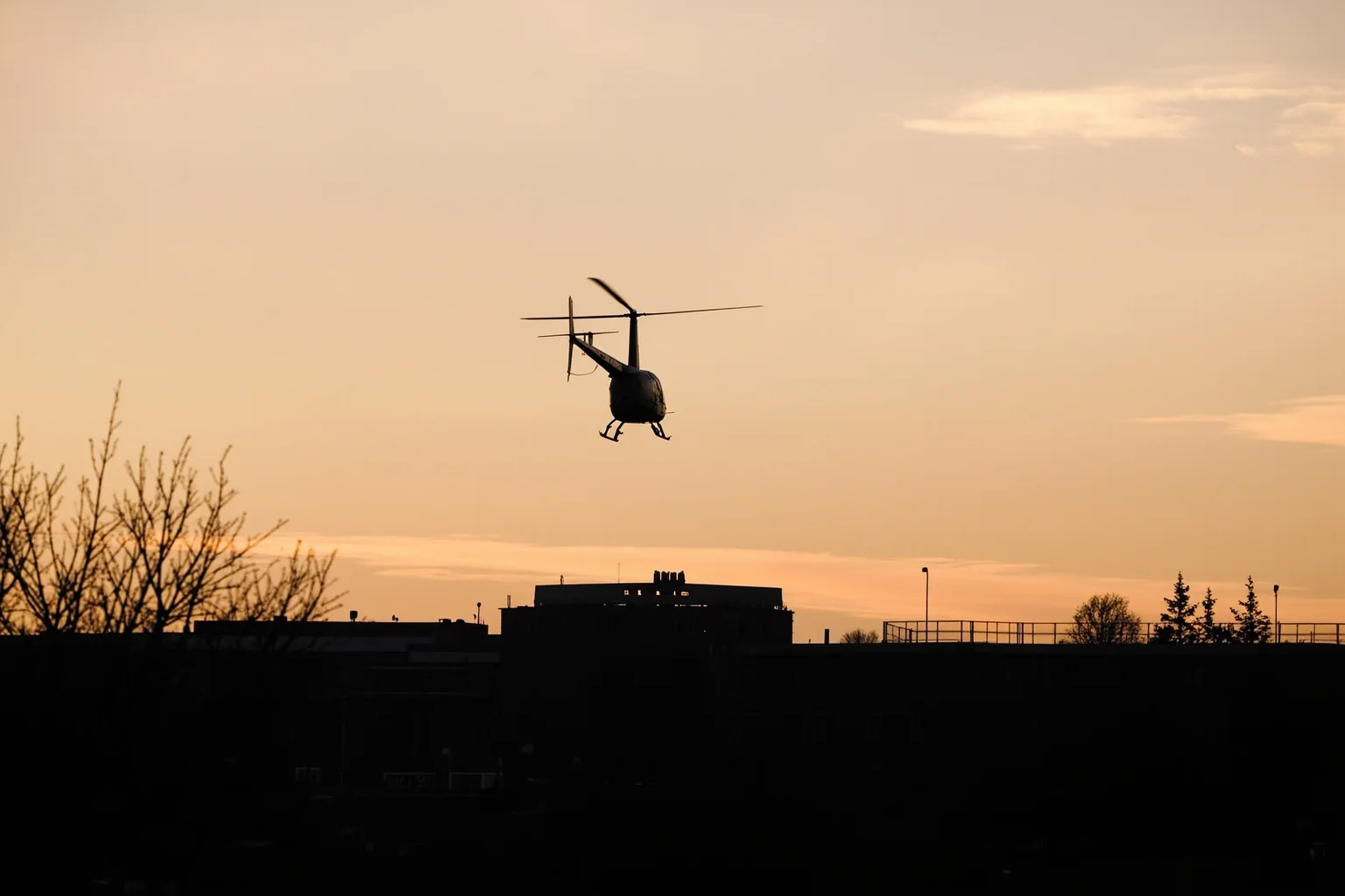 The Most Daring Prison Escapes in History 11 A helicopter hovering low above a walled prison exercise yard at dusk