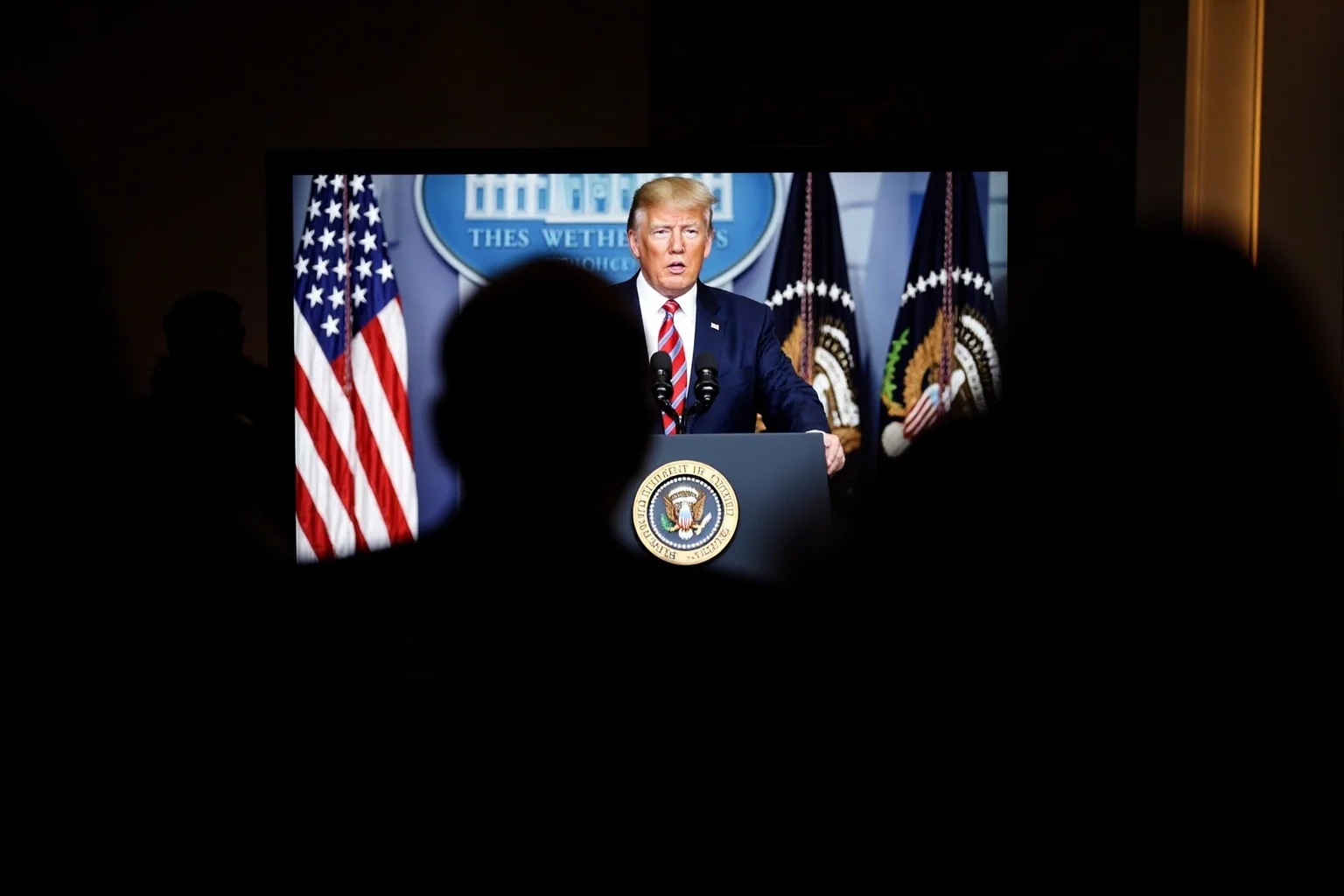Most Important Historical Events Televised Live 22 A late-night TV screen showing a formal address from a lectern with a presidential seal, captured in a hushed newsroom