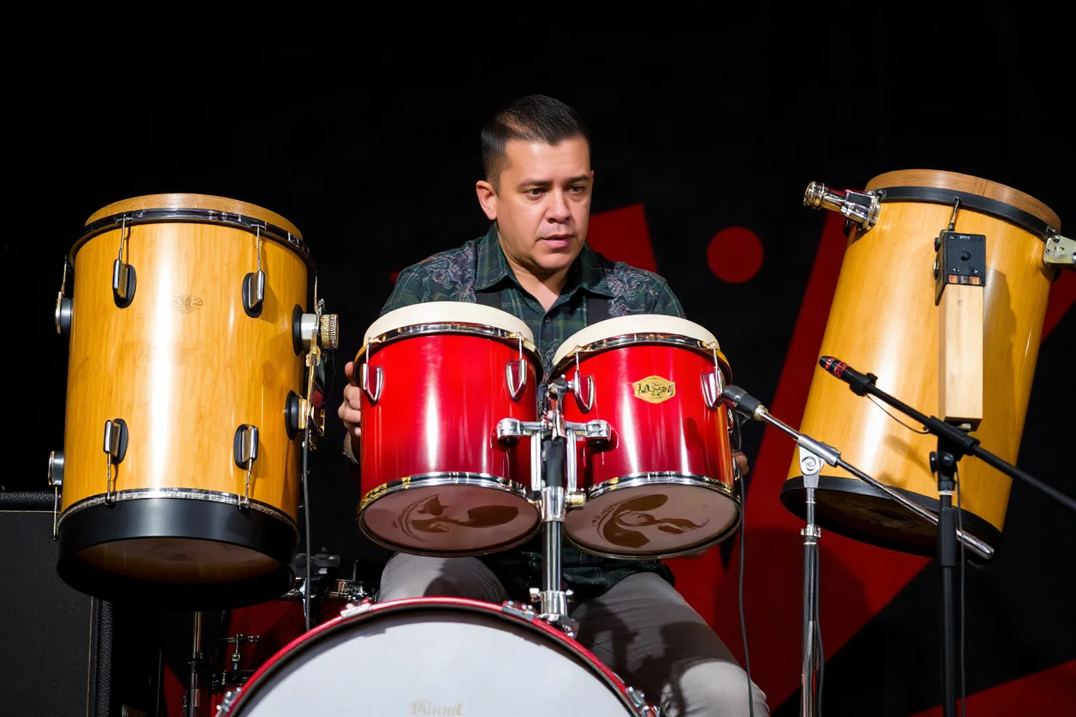 A Latin percussion-influenced drummer playing congas and a hybrid drum kit with vibrant energy