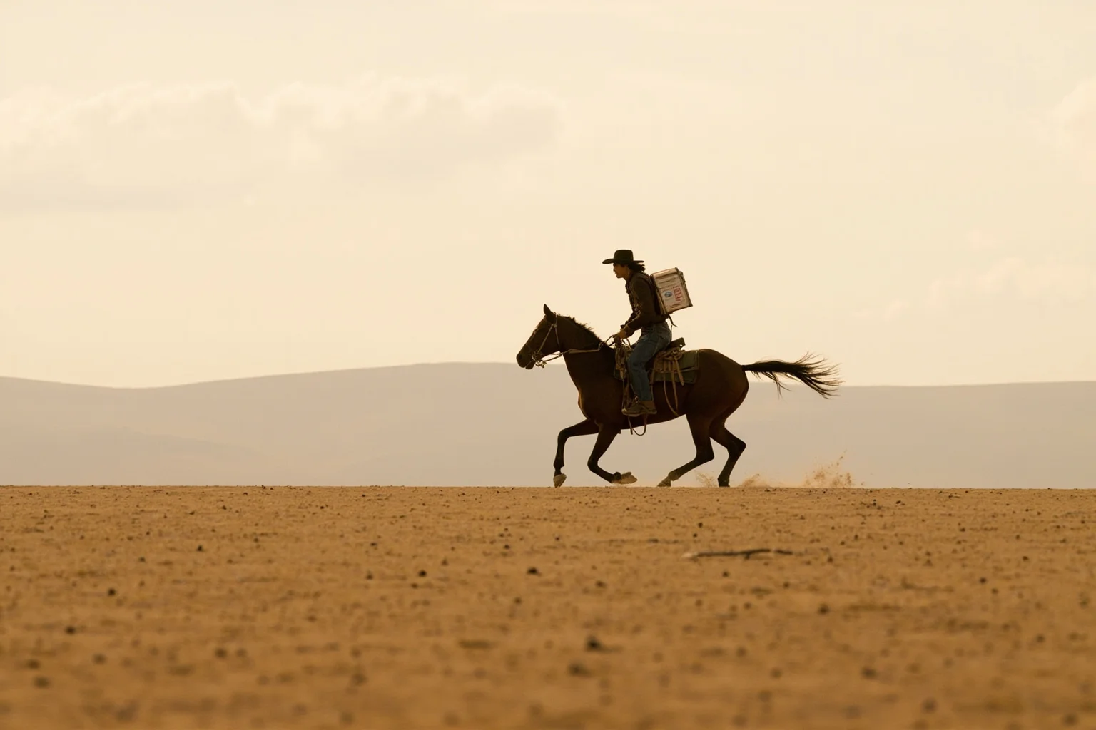 A lone rider on horseback galloping across an empty plain carrying a mail satchel, evoking the Pony Express
