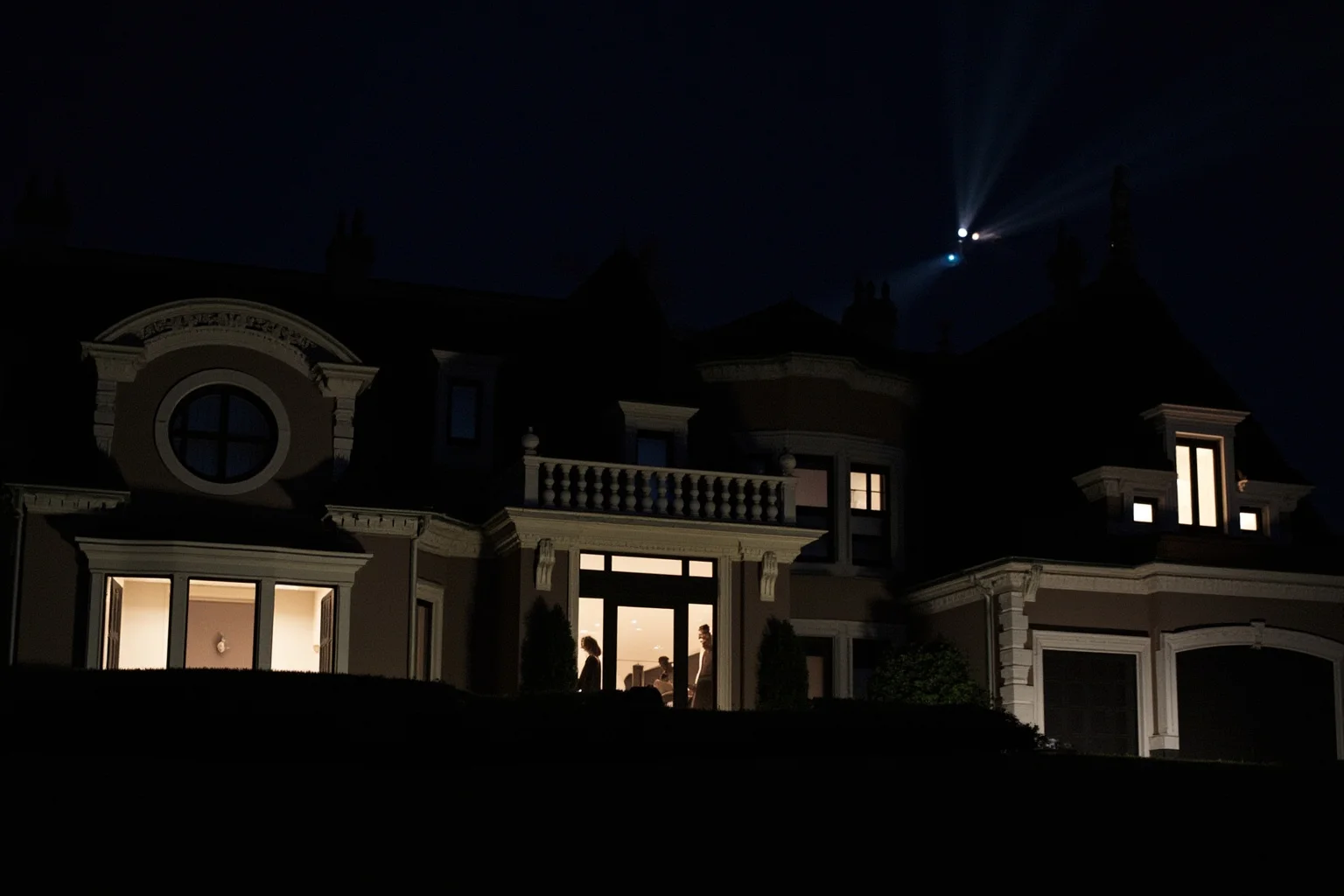 22 Hollywood Stars Whose Lives Ended in Tragedy 12 A luxury 2000s mansion exterior at night with tabloid photographers' flashes faintly visible in the distance