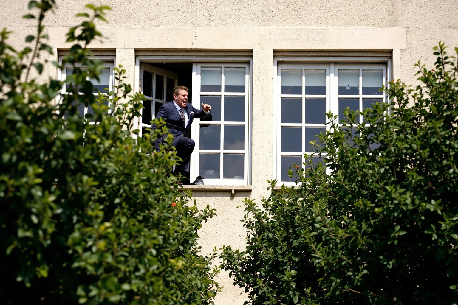 The Most Daring Prison Escapes in History 14 A man leaping from a courthouse window into thick bushes on a sunny afternoon