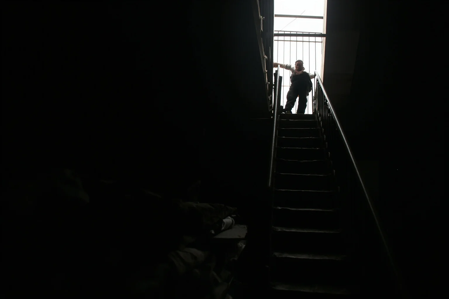 The Most Daring Prison Escapes in History 17 A man squeezing through a narrow skylight above a prison workshop at night