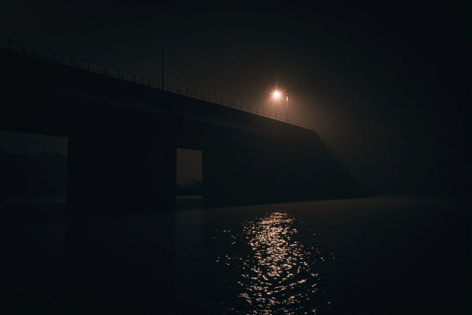 Amazing Facts About Claude Monet: His Life and 10 Greatest Paintings 7 A moody nighttime river scene with a solitary rippling reflection under a bridge, somber impressionist tones