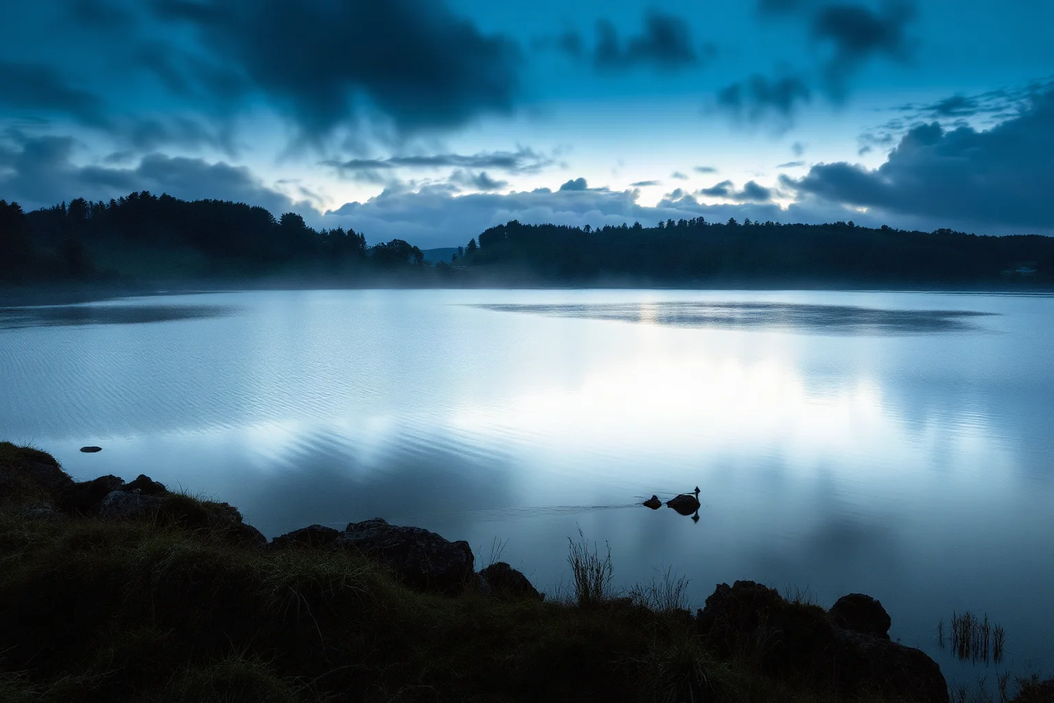 A moody watercolor landscape of an Irish countryside lake at twilight, evoking mystical poetry