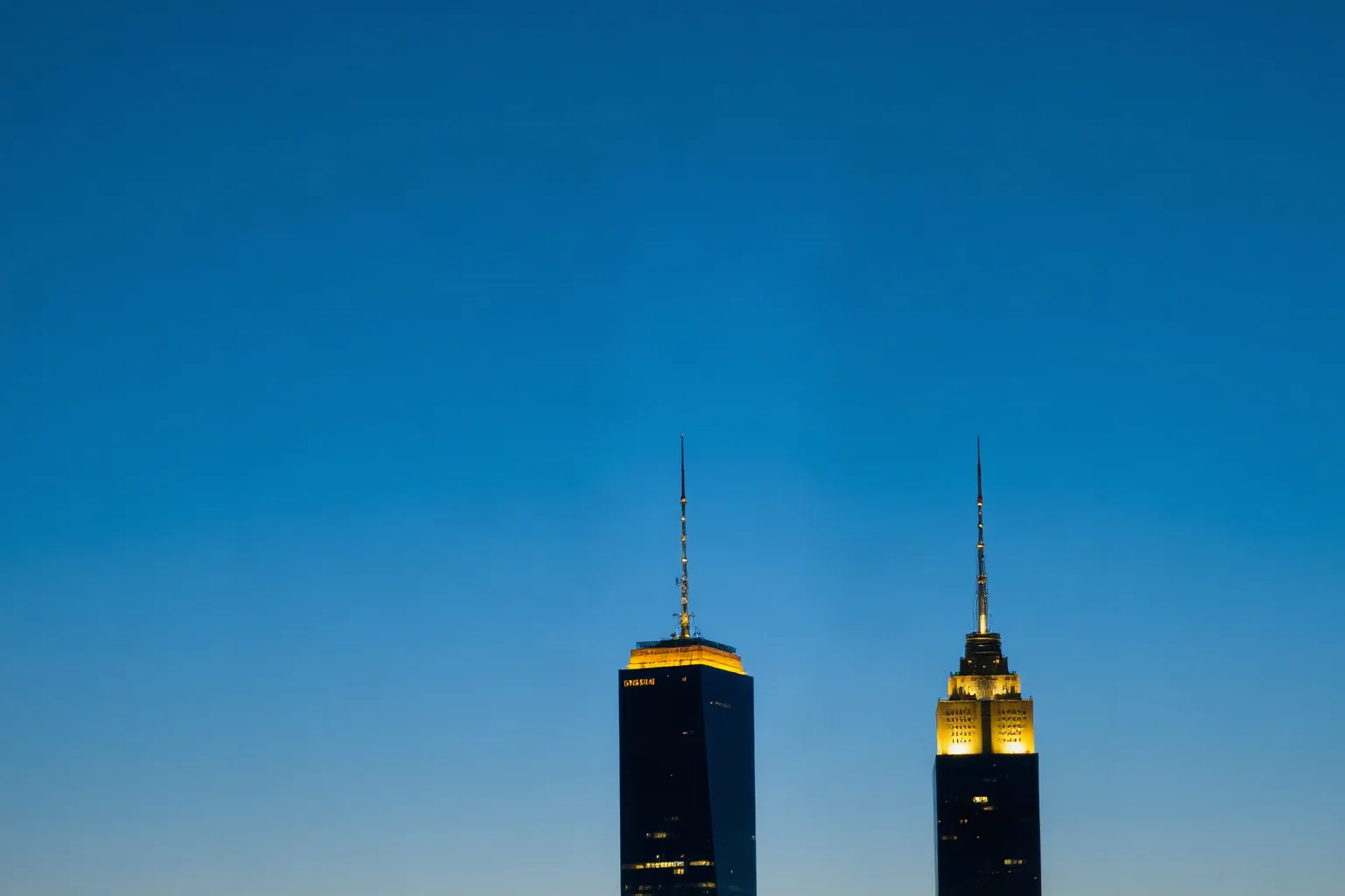 A pair of illuminated skyscraper towers silhouetted against a clear blue morning sky, respectful and non-graphic symbolic illustration.