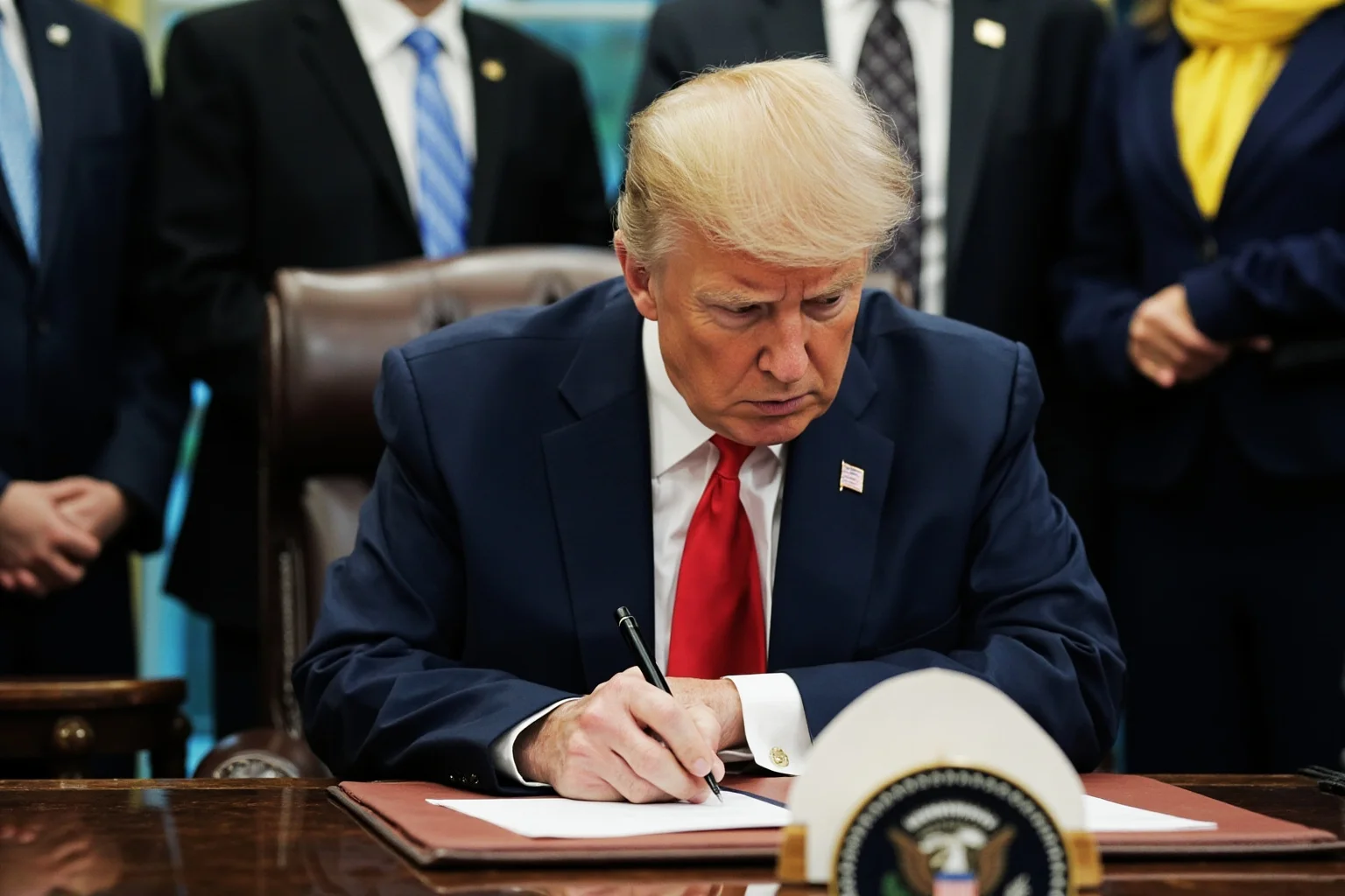 Facts About Ulysses S. Grant: 20 Facts and 10 Misconceptions Busted 16 A president at a desk signing legislation, with the presidential seal visible, surrounded by advisors