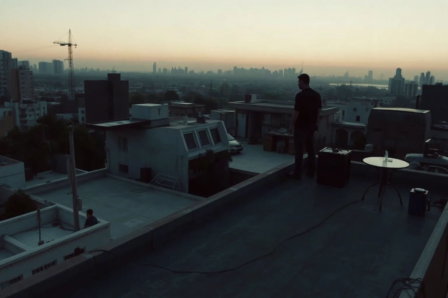 A quiet rooftop scene at dawn over a Latin American city, symbolizing a dramatic final standoff