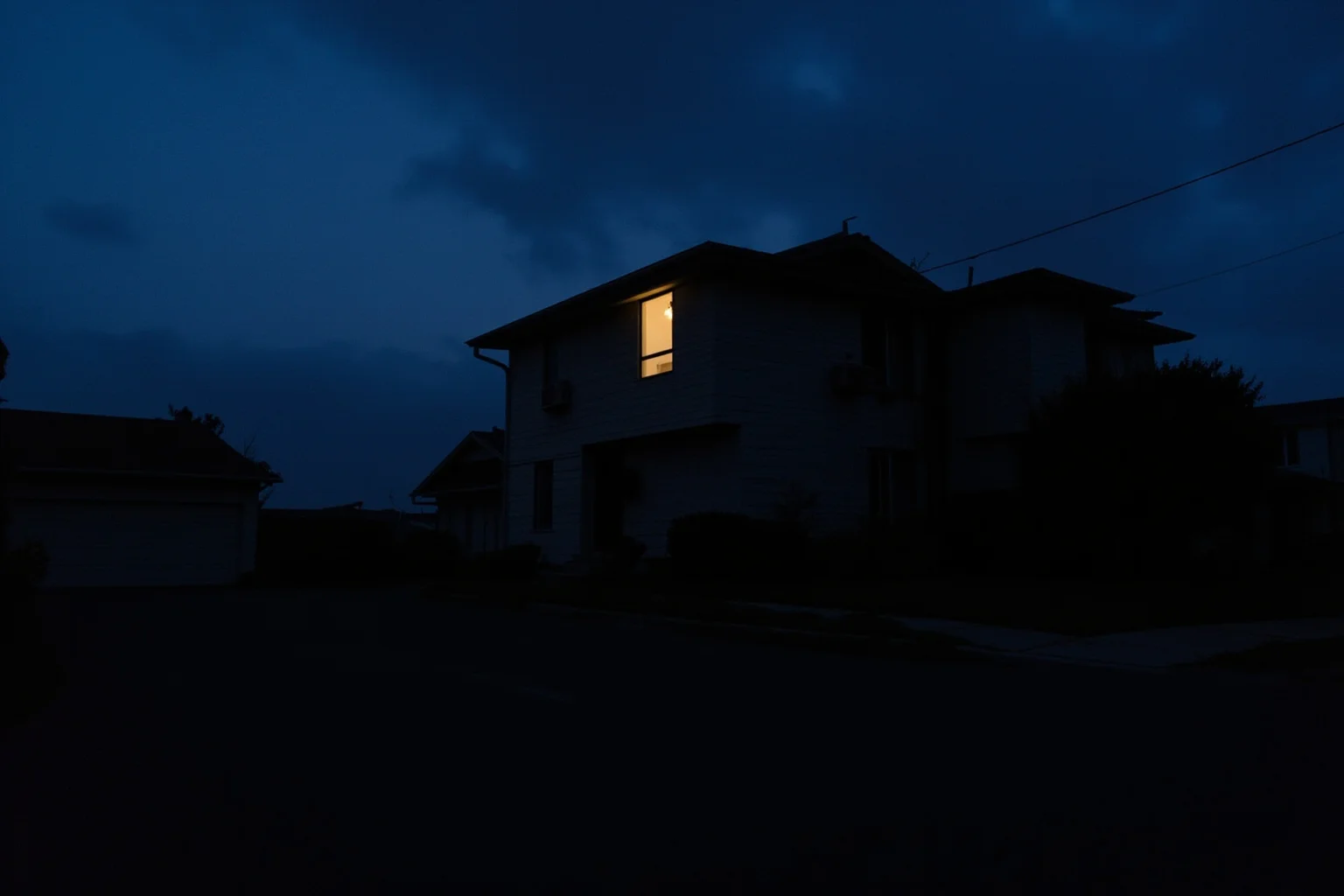 22 Hollywood Stars Whose Lives Ended in Tragedy 11 A quiet suburban house at dusk with a single lit window, evoking private struggles behind a public image