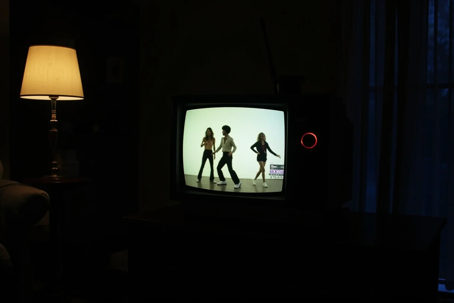 A retro television glowing in a dark living room displaying an abstract music video scene with dancers in silhouette, evoking early MTV culture