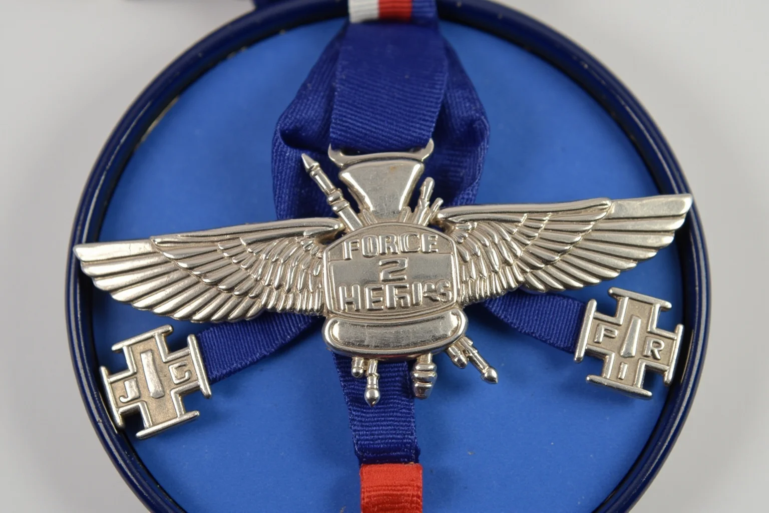 Highest Military Decorations: 20 Rare and Obsolete Medals You'll Never See Again 16 A silver cross medal with wing motifs on a blue striped ribbon, evoking an air force heroism award