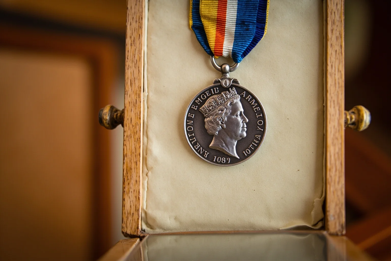 Highest Military Decorations: 20 Rare and Obsolete Medals You'll Never See Again 12 A silver medal with a monarch's profile on a striped ribbon, displayed in a vintage wooden presentation case