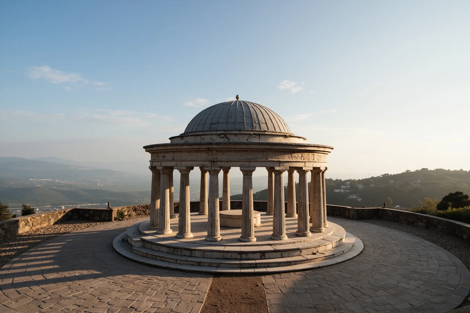 A small circular domed temple with a ring of classical columns on a quiet hilltop courtyard
