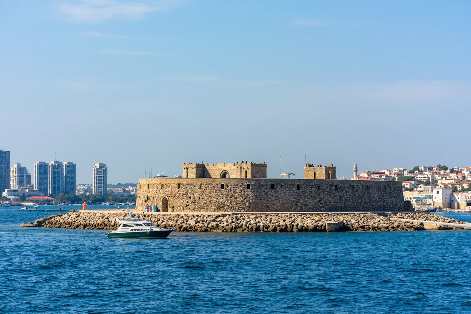 A small fortified island with old stone fort walls surrounded by a city harbor