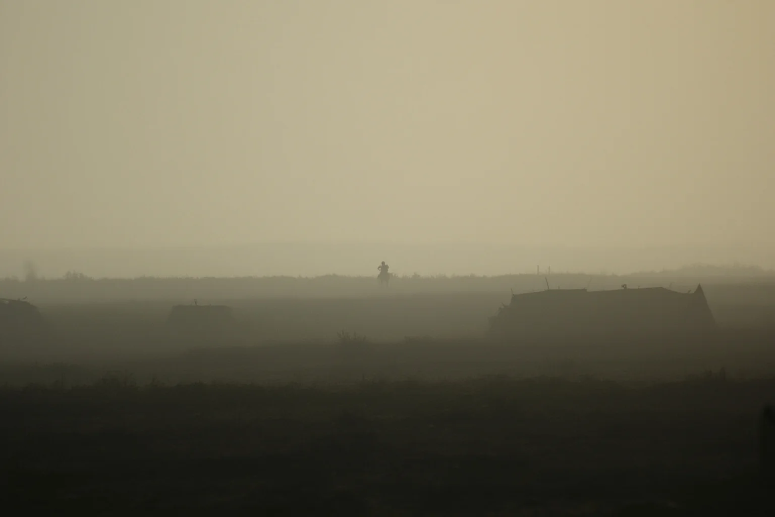 20 Famous Historical Quotes That Were Taken Out of Context 14 A smoky 19th-century battlefield landscape with scattered tents and a lone rider on the horizon, muted tones