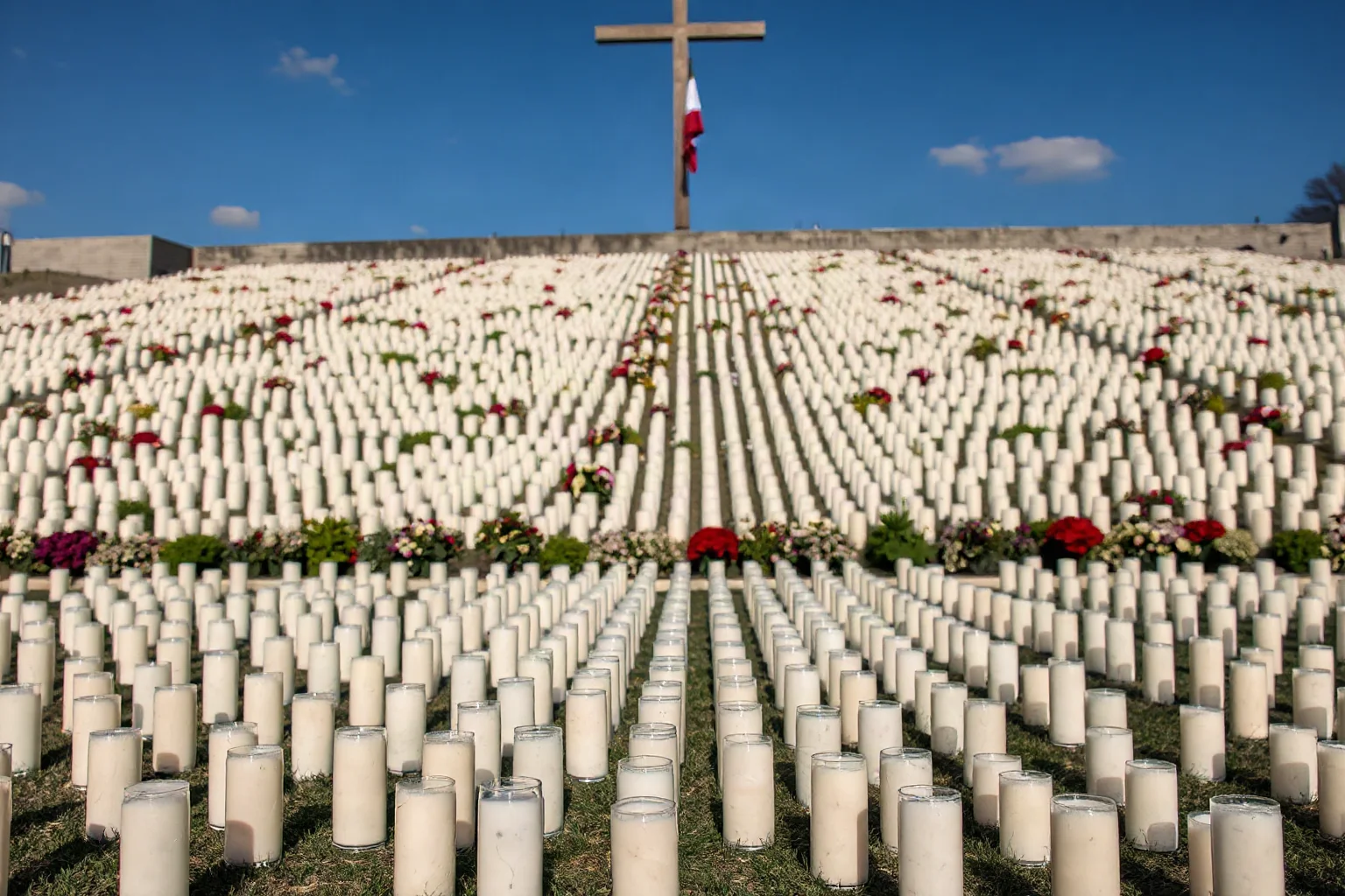 A solemn memorial wall or field of candles representing victims of a historical genocide, respectful and non-graphic