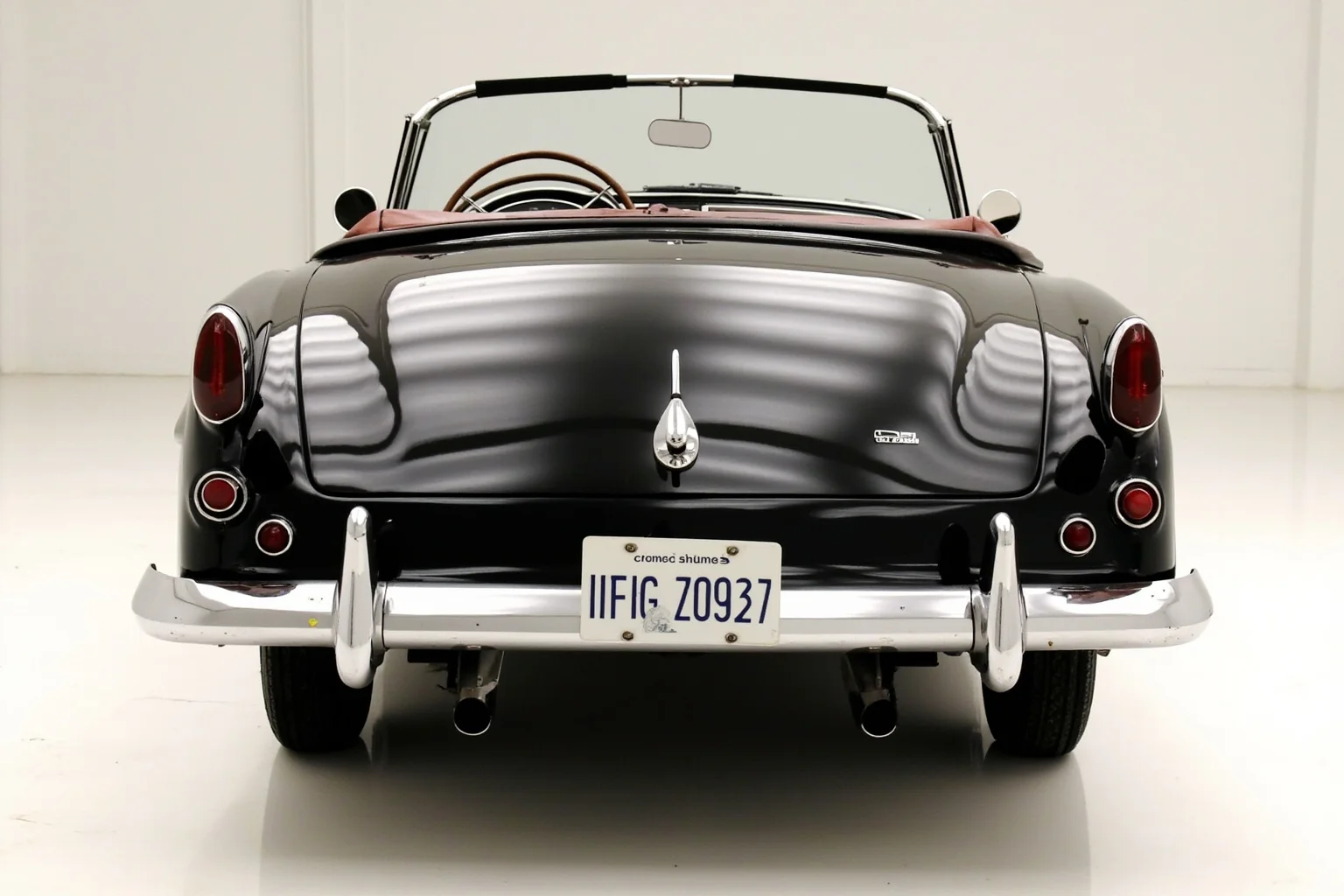A sporty 1950s two-seat convertible with a fiberglass body and simple round taillights