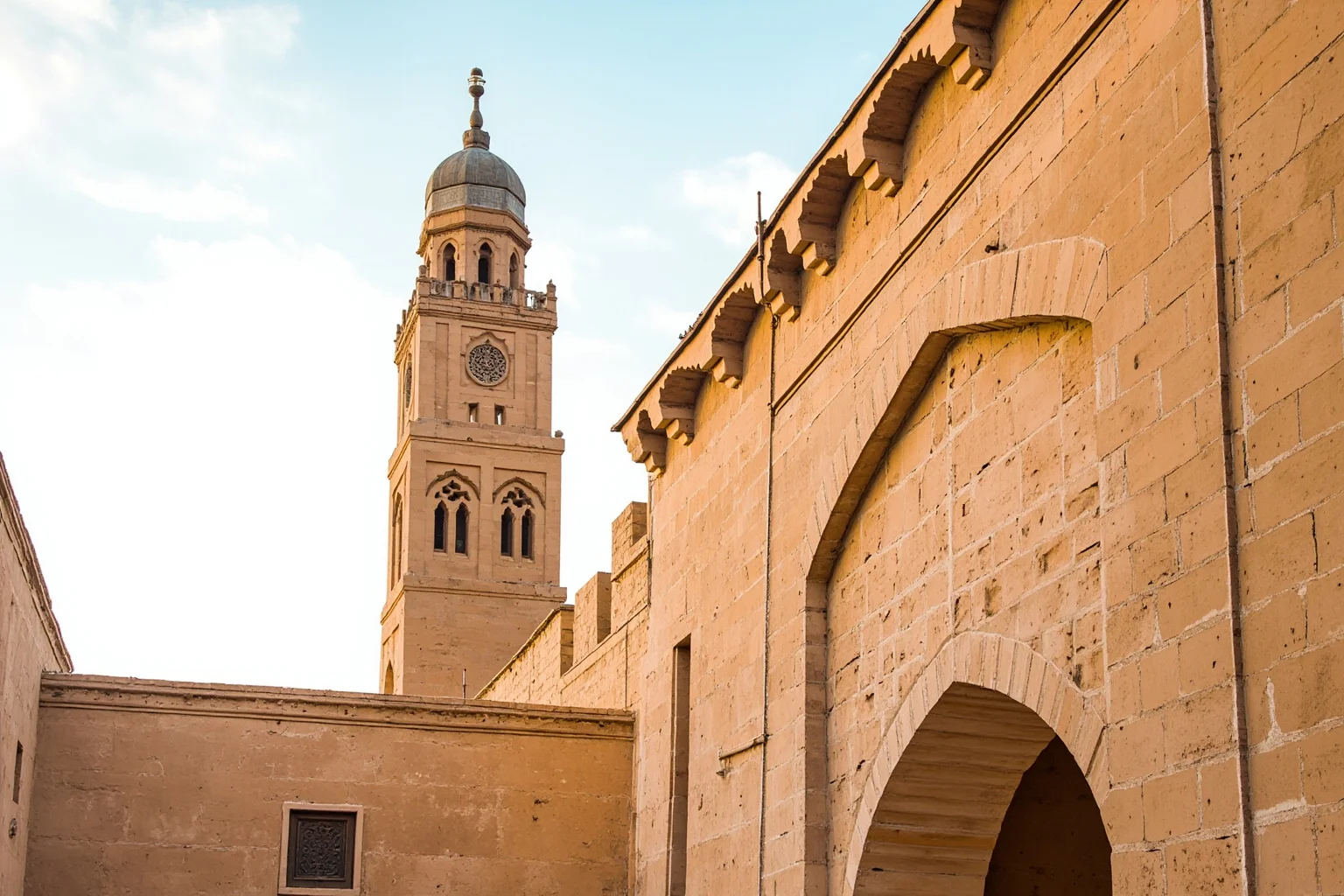 25 Captivating Facts About the Persian Empire 11 A tall traditional Persian windcatcher tower rising above a sand-colored mudbrick building