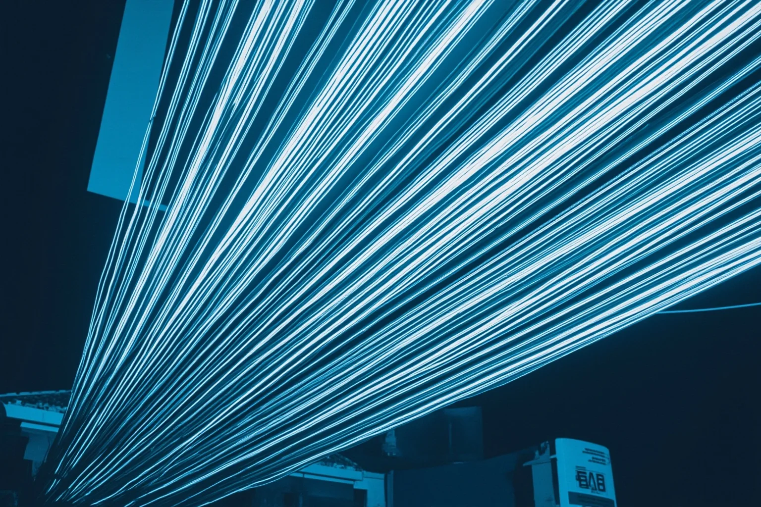 A telecom office building exterior with tangled fiber-optic cables in the foreground