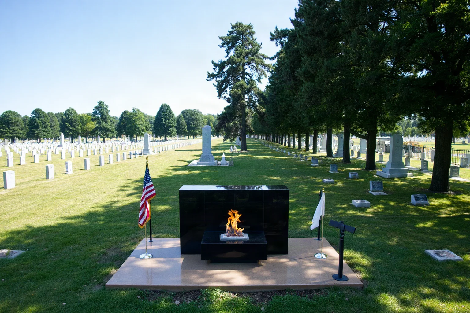 A vast memorial cemetery with an eternal flame monument and rows of trees, quiet and respectful atmosphere